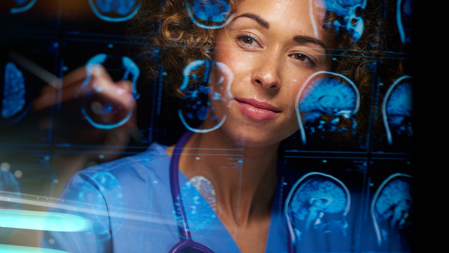 woman in scrubs inspecting brain scans