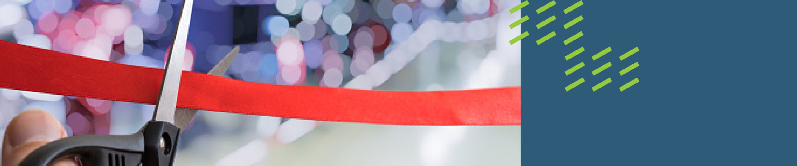 image of scissors cutting a red ribbon in front of a crowd