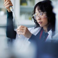 young asian woman testing a sample in a lab