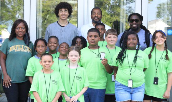 Noblis employees with students at Berkley Community Center event for young scientists.