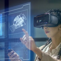 woman in VR glasses touching a screen with an image of a digital engine and specs.