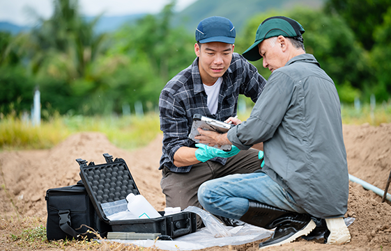 two men working outside with a portable sequencing kit