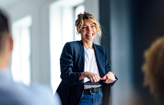 woman smiling and presenting to others