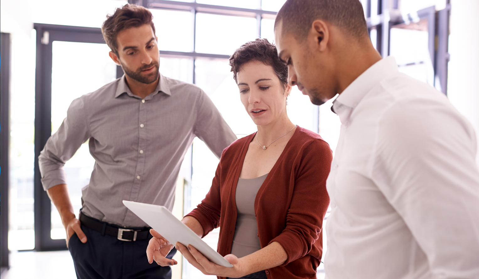 three business owners look together at a ventures offer