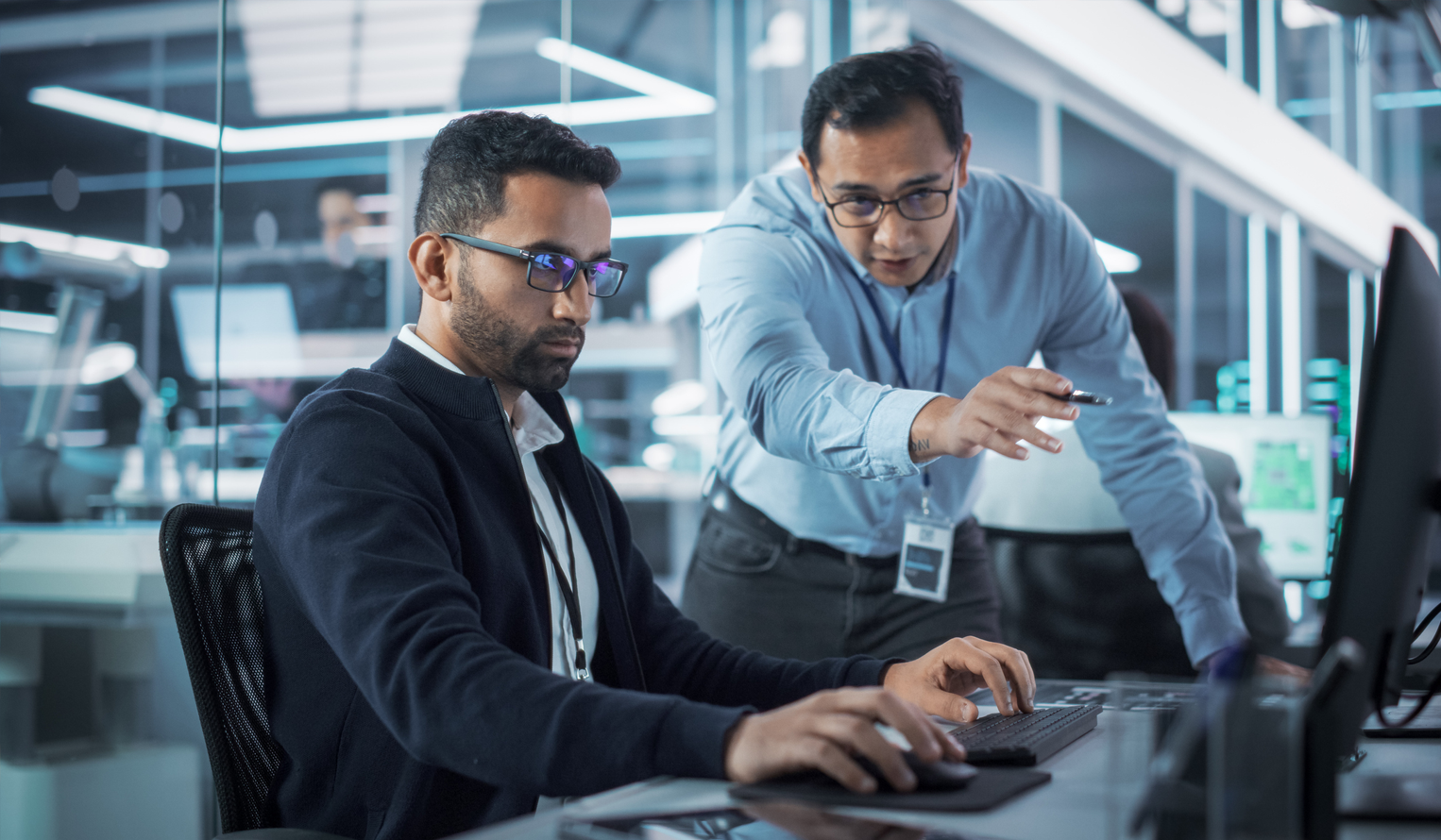 project managers using a computer and AI to assess a situation