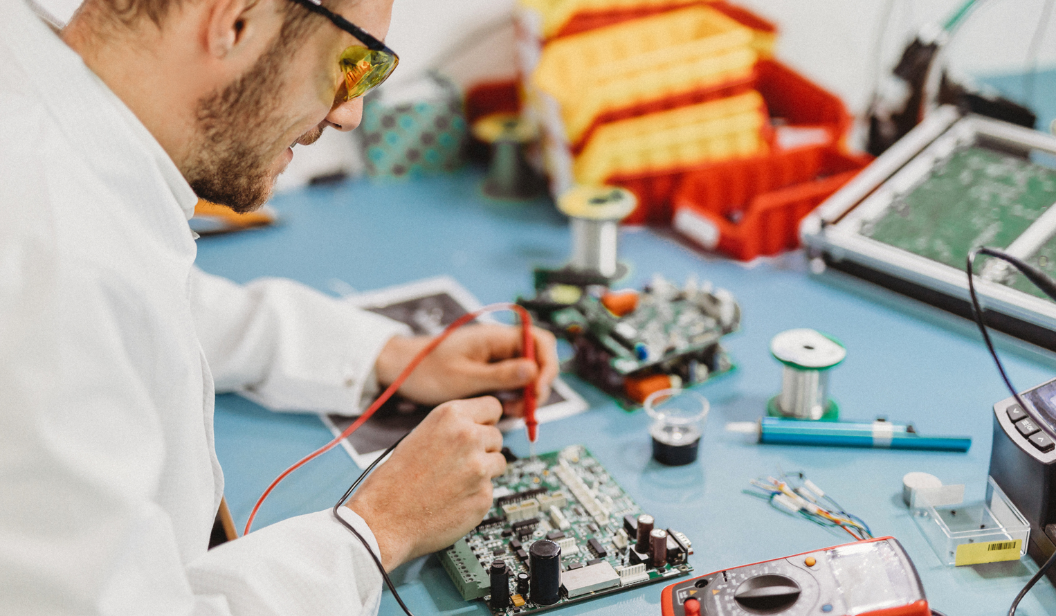 man working on a robotics assembly in an autonomy lab
